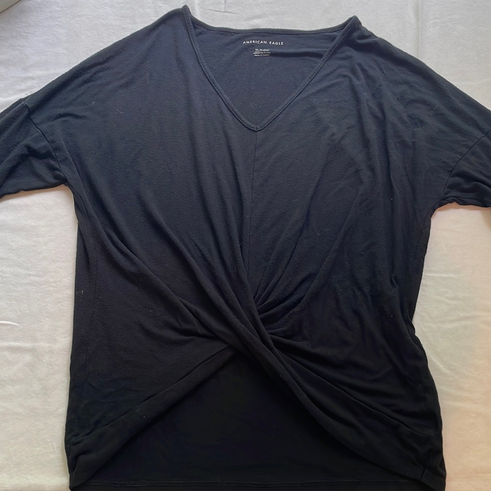 Long sleeve black flowy shirt with unique waistline